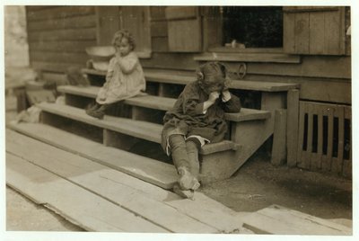 5 year old Olga Schubert began work about 5:00 A.M. helping her mother in the Biloxi Canning Factory, Mississippi, picking shrimps. She was tired out and refused to be photographed, 1911 by Lewis Wickes Hine